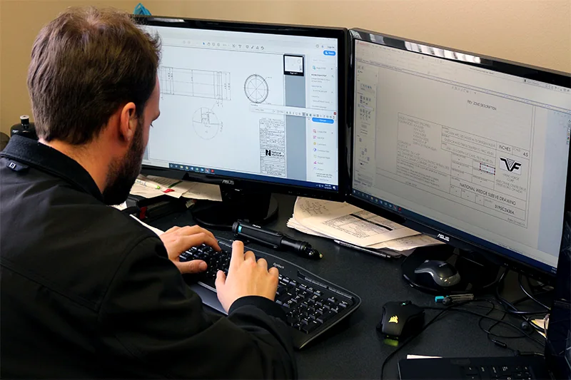 Engineer reviewing CAD drawings